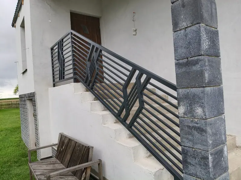 Balustrada schodów zewnętrznych z geometrycznym motywem, widok z dołu schodów
